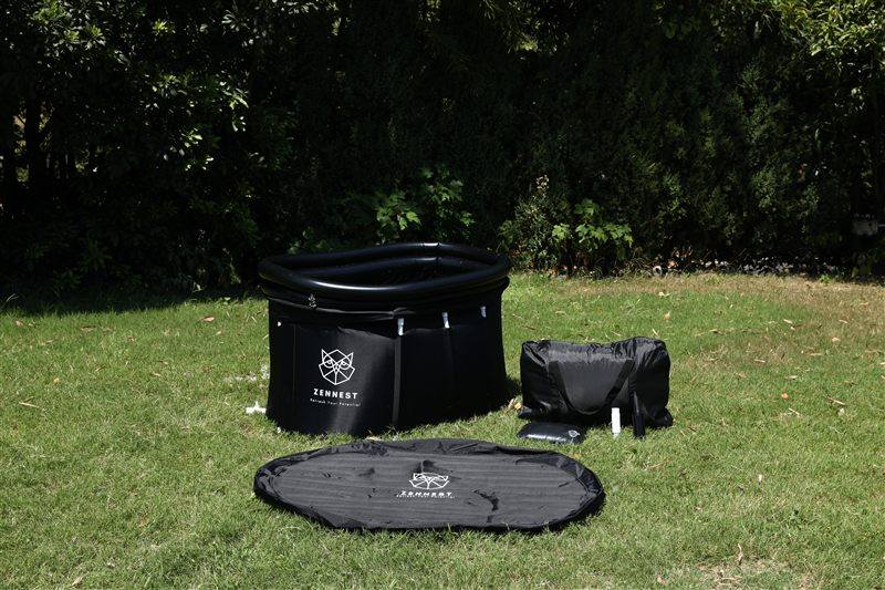 The full Oval 150 kit on grass: tub, insulated cover, carry bag and pump